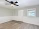 A cozy living room features new floors, wainscotting and a bright window at 473 Forest Ave, Brooksville, FL 34601