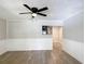 Bright living room with modern flooring, fresh paint, wainscoting and a view to the updated kitchen at 473 Forest Ave, Brooksville, FL 34601