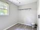 Clean utility room featuring updated flooring, a storage shelf, and a bright window at 473 Forest Ave, Brooksville, FL 34601