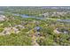 Beautiful aerial view of the property nestled among mature trees, with convenient access to the Hillsborough River at 4805 E Regnas Ave, Tampa, FL 33617