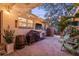 Cozy backyard patio with a grill, outdoor seating, ambient string lights, and mature landscaping at 4805 E Regnas Ave, Tampa, FL 33617