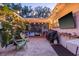Quaint backyard with patio, BBQ, garden area, outdoor seating, and string lights for a cozy feel at 4805 E Regnas Ave, Tampa, FL 33617