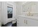 Bright bathroom featuring sleek finishes, modern hardware and fixtures, and a window at 4805 E Regnas Ave, Tampa, FL 33617