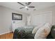 This bedroom offers ample closet space, hardwood floors, and a ceiling fan at 4805 E Regnas Ave, Tampa, FL 33617