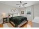Comfortable bedroom featuring hardwood floors, a ceiling fan and comfortable decor at 4805 E Regnas Ave, Tampa, FL 33617
