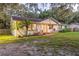 Charming single story home with a brick facade, lush lawn, and mature landscaping, exuding curb appeal at 4805 E Regnas Ave, Tampa, FL 33617