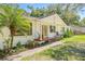 Side view showcasing the home's architectural details and surrounding landscaping at 4805 E Regnas Ave, Tampa, FL 33617
