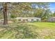 Scenic view of the home's front yard, complete with lush greenery and a serene ambiance at 4805 E Regnas Ave, Tampa, FL 33617