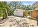 Detached one-car garage with basketball hoop on a concrete driveway and wooden privacy fence in the backyard at 4805 E Regnas Ave, Tampa, FL 33617