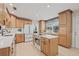 Spacious kitchen featuring custom cabinets, a center island with range, and stainless steel appliances at 4805 E Regnas Ave, Tampa, FL 33617