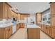 Open kitchen with custom cabinets, tile floors, stainless appliances, and plenty of countertop space at 4805 E Regnas Ave, Tampa, FL 33617