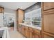 Kitchen counter featuring custom cabinets, stainless steel appliances, and a view to the living room at 4805 E Regnas Ave, Tampa, FL 33617