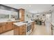Kitchen with custom cabinets, countertops, stainless appliances, and adjoining dining area at 4805 E Regnas Ave, Tampa, FL 33617