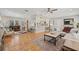 Open concept living space with hardwood floors, modern furnishings, and seamless flow to the kitchen at 4805 E Regnas Ave, Tampa, FL 33617