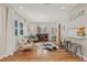 Cozy living room showcasing hardwood floors, chic furnishings, and a welcoming ambiance at 4805 E Regnas Ave, Tampa, FL 33617