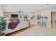 Bright, open living room with hardwood floors, a ceiling fan, and comfortable seating near the breakfast bar at 4805 E Regnas Ave, Tampa, FL 33617