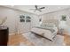 This main bedroom boasts hardwood floors, a ceiling fan and neutral tones at 4805 E Regnas Ave, Tampa, FL 33617
