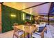 Outdoor dining area with a TV, surrounded by lush greenery, and great lighting at 4805 E Regnas Ave, Tampa, FL 33617