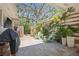 Cozy outdoor patio with potted plants, a grill, and comfortable seating, creating a perfect spot for relaxation at 4805 E Regnas Ave, Tampa, FL 33617