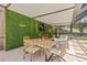 Stylish patio featuring modern furniture, a vibrant green wall, and an inviting ambiance for relaxation and socializing at 4805 E Regnas Ave, Tampa, FL 33617
