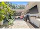 Beautiful outdoor patio area with a grill, charming string lights, tropical plants, and a cozy seating arrangement at 4805 E Regnas Ave, Tampa, FL 33617