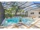Beautiful, screened-in pool with modern design elements and lush landscaping for a tranquil retreat at 4805 E Regnas Ave, Tampa, FL 33617