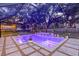 Beautiful screened-in pool with tiled surround, underwater lighting, and a lovely mosaic water feature at 4805 E Regnas Ave, Tampa, FL 33617