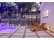 Relaxing poolside patio featuring modern lounge chairs and access to the home at 4805 E Regnas Ave, Tampa, FL 33617