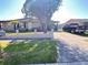 Quaint single-story home with a well-kept lawn, long driveway, and mature landscaping at 4812 Bonita Vista Dr, Tampa, FL 33634