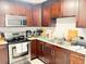 Efficient kitchen featuring dark wood cabinets, modern stainless steel appliances at 4812 Bonita Vista Dr, Tampa, FL 33634