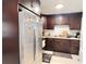Well-appointed kitchen with dark wood cabinetry and stainless steel refrigerator at 4812 Bonita Vista Dr, Tampa, FL 33634