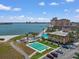 Beautiful aerial view showcasing waterfront condominiums with a pool, shuffleboard courts and a picturesque waterfront view at 5130 Brittany S Dr # 604, St Petersburg, FL 33715