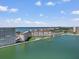 Panoramic aerial view of condos with waterfront access, pool, dock, and city skyline in distance at 5130 Brittany S Dr # 604, St Petersburg, FL 33715