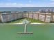 Aerial view showcasing condo buildings with dock, waterfront access and lush landscaping around the property at 5130 Brittany S Dr # 604, St Petersburg, FL 33715