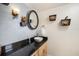 Contemporary half bath with black granite countertop and decorative nautical theme at 5130 Brittany S Dr # 604, St Petersburg, FL 33715