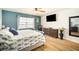 Primary bedroom with a king bed, coastal decor, water views, and wood-look flooring at 5130 Brittany S Dr # 604, St Petersburg, FL 33715