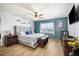 Primary bedroom with a king bed, coastal decor, water views, and wood-look flooring at 5130 Brittany S Dr # 604, St Petersburg, FL 33715