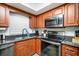 This kitchen has granite countertops, stainless steel microwave, stove, and appliances at 5130 Brittany S Dr # 604, St Petersburg, FL 33715