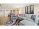 Comfortable living room featuring a large couch, stylish accents, and an open dining area at 5130 Brittany S Dr # 604, St Petersburg, FL 33715
