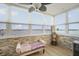 Bright sunroom with stone accent wall, large windows, and amazing water views at 5130 Brittany S Dr # 604, St Petersburg, FL 33715