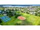 Aerial view of neighborhood with tennis courts, baseball field, and a view of the water at 5340 Denver Ne St, St Petersburg, FL 33703