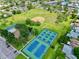 Aerial view of neighborhood featuring tennis courts, a baseball field, playground, and green space at 5340 Denver Ne St, St Petersburg, FL 33703