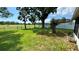 Backyard view of the fenced-in yard, with trees, and open green space at 5340 Denver Ne St, St Petersburg, FL 33703