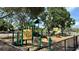 Community playground featuring slides and green and yellow bars with mature trees and shade at 5340 Denver Ne St, St Petersburg, FL 33703