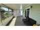 Enclosed and covered screened porch with a set of chairs, block wall, and views of the backyard at 5340 Denver Ne St, St Petersburg, FL 33703