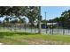 Tennis courts with net surrounded by greenery for residents to play and practice at 5340 Denver Ne St, St Petersburg, FL 33703