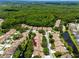 Aerial view of townhouses situated by a canal and close to a lush green forest at 5524 Salem Square N Dr, Palm Harbor, FL 34685