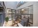 Charming atrium with seating area that lets in natural light reflecting into the kitchen and dining room through the windows at 5524 Salem Square N Dr, Palm Harbor, FL 34685