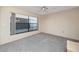 Bedroom featuring large window, neutral carpet and ceiling fan at 5524 Salem Square N Dr, Palm Harbor, FL 34685