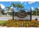 A decorative metal sign for Devonshire Salem Square Windermere is enhanced with flowers and lush tropical palms at 5524 Salem Square N Dr, Palm Harbor, FL 34685